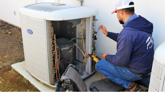 A technician working on an AC unit.