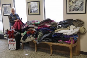 Sheryl Berry sorting 63 coats from Lincoln Elementary School